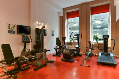 a gym with many exercise equipment in a room at Fraser Suites Glasgow in Glasgow