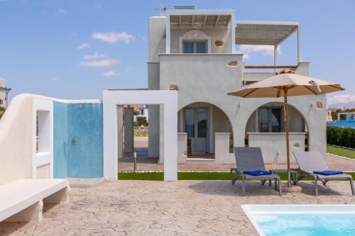 a house with chairs and an umbrella and a swimming pool at Sun and Moon Villas in Aliko Beach