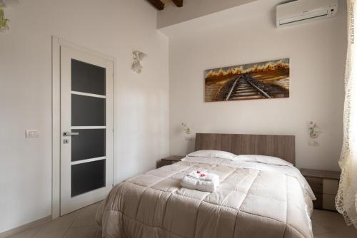 a bedroom with a bed with two towels on it at La Meridiana in Piacenza
