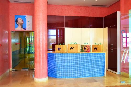 a lobby with a counter with bags on it at Regency Hotel & Spa in Monastir