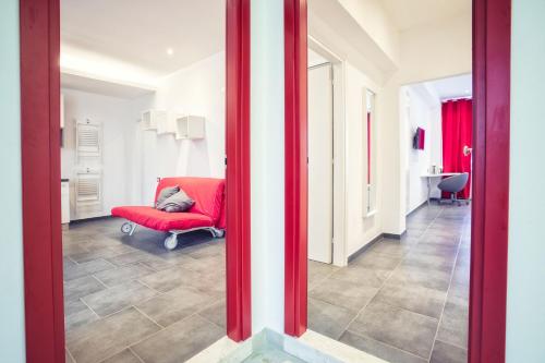 a red chair and a red chair in a room at Excelsior in Piombino