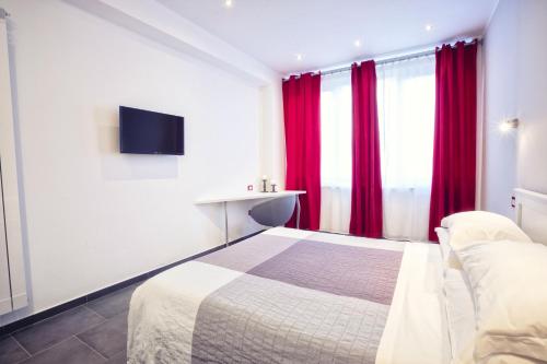a bedroom with a bed with red curtains and a tv at Excelsior in Piombino