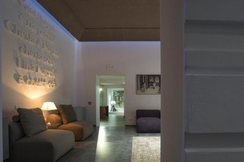 a living room with a couch and a chair at Hotel Santa Brigida in Naples