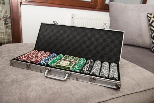 a suitcase filled with lots of dominoes on a couch at Apartment Hobbit - Bjelašnica in Bjelašnica