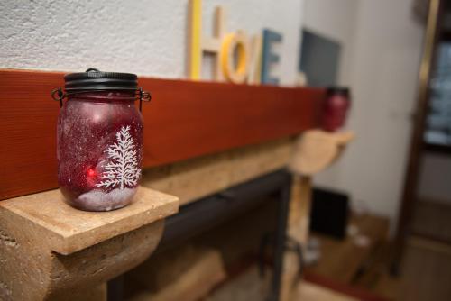 a red mason jar with a christmas decoration in it at Apartment Hobbit - Bjelašnica in Bjelašnica