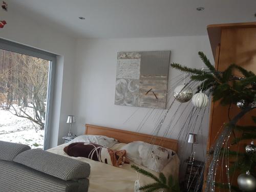 a bedroom with a dog laying on a bed at Agro Breza domek nad samym jeziorem- sauna ogrodowa in Lipusz