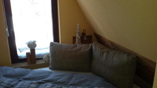 a bedroom with a bed with a large window at Finnhütte Amelie in Gager