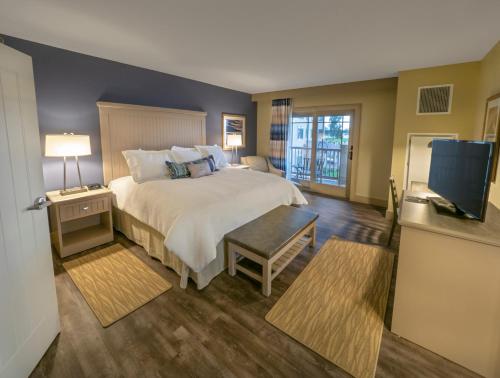 a hotel room with a bed and a television at Chautauqua Harbor Hotel - Jamestown in Celoron