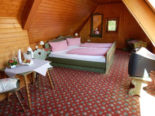 a bedroom with a bed and a tv in a attic at Gasthof Löwen GmbH in Heitersheim