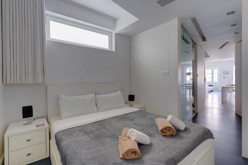 a bedroom with a bed with towels on it at Valletta Studio Apartment in Valletta