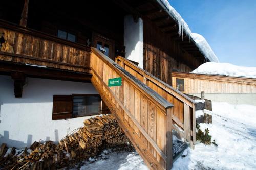 a wooden staircase outside of a building in the snow at Hof Hintererb in Kitzbühel