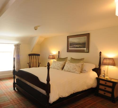 a bedroom with a large bed and a window at The Rising Sun in Umberleigh Bridge