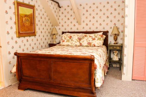 a bedroom with a wooden bed in a room at The Nutmeg Inn in Meredith