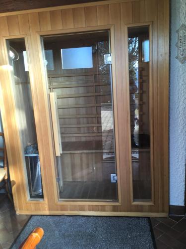 a glass door with two windows in a house at Fouettara in Firminy