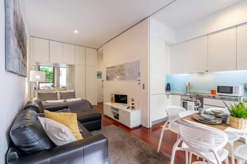 a living room with a couch and a table at Merc Porto Clérigo's Place in Porto