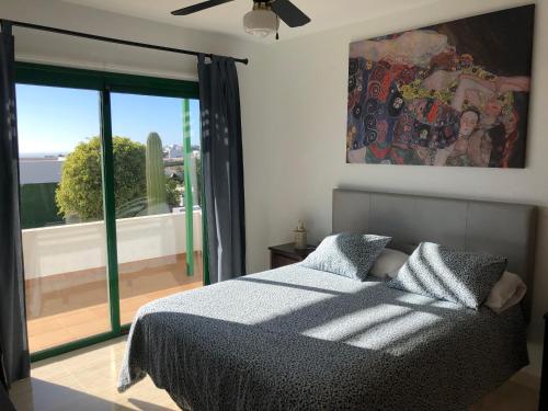 sypialnia z łóżkiem i dużym oknem w obiekcie Casa tranquila con vistas en la colina de tías w Tías