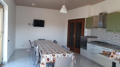 a kitchen with a table with a table cloth on it at LA CASA DI MAMMA 'NTO in Castrofilippo