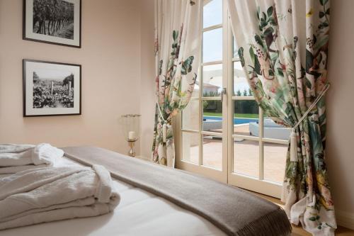 a bedroom with a bed and a large window at Villa Hermitage in Vabriga