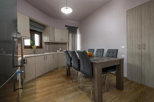 a kitchen and dining room with a table and chairs at Simantiris Apartment in Asímion