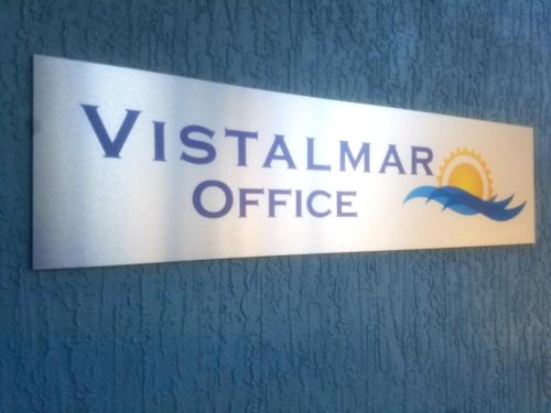 a sign for a vietnamese office on a wall at Vistalmar Beach Resort in Deerfield Beach