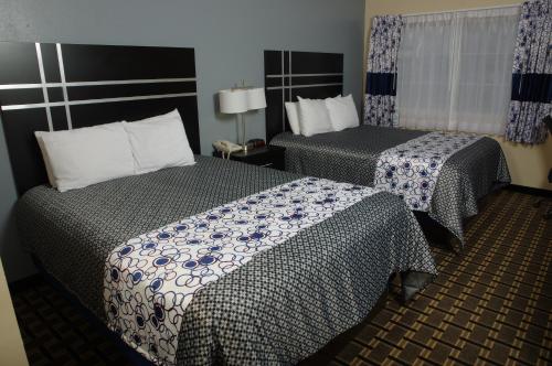 a hotel room with two beds in a room at DUTCH INN AND SUITES in Orange City
