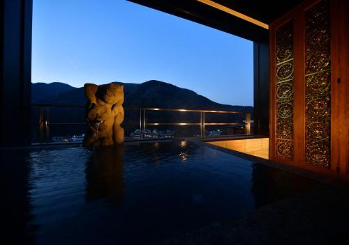 a view of a swimming pool at night at Balinese onsen ryokan Hakone Airu in Hakone