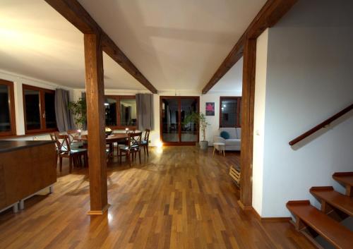 a living room with a table and a dining room at Dom Przy Lesie in Wisła
