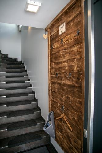 a stairway with a wooden wall and a wooden door at Appartement Alpenliebe in Rauris