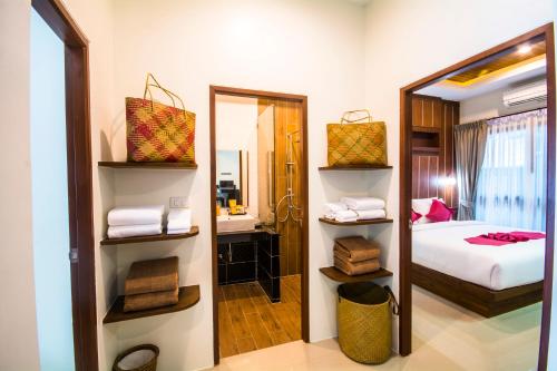 a bedroom with a mirror and a bed at The Scene Cliff View Villas in Ao Nang Beach