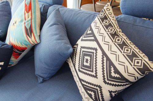 a tie sitting on a couch with pillows at Villent Kujukuri Arrow in Kujukuri