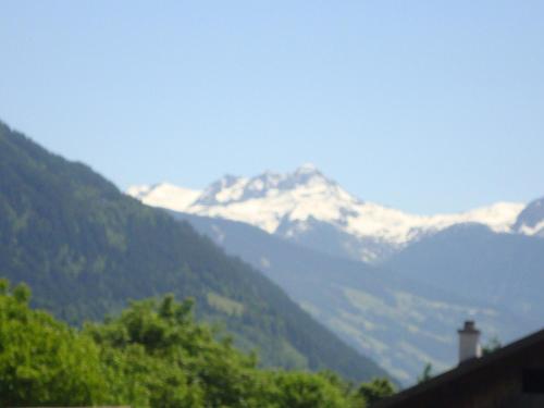 a mountain range with snow capped mountains in the distance at Gästehaus Schwoagerhof in Fügen