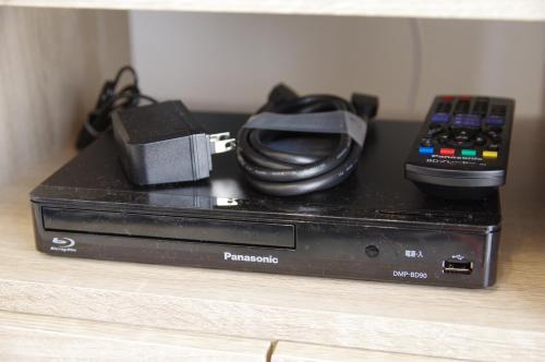 a dvd player sitting on a table with a remote control at Villent Kujukuri Arrow in Kujukuri