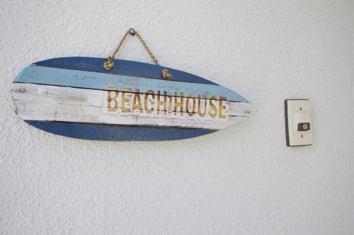 a sign for a beaching house hanging on a wall at Villent Kujukuri Arrow in Kujukuri