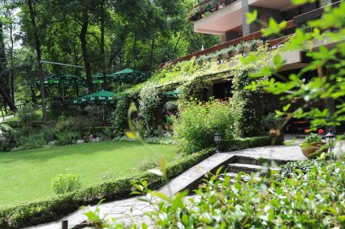 a garden in front of a building at Hotel Restaurant Dreri in Tirana