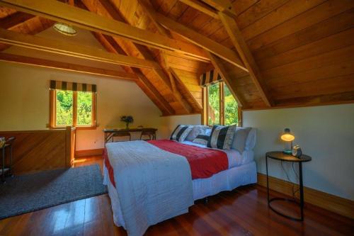 アカロアにあるGate Keepers Cottageの木製の天井の客室で、ベッドルーム1室(ベッド1台付)