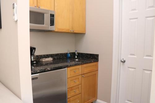 a kitchen with a sink and a microwave at Stylish Downtown Studio, #32 in Boston