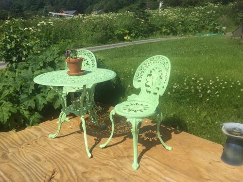 a table and two chairs sitting on a deck at Homer Stay and Play in Homer