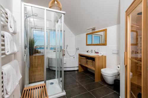 a bathroom with a shower and a toilet and a sink at Newport in Olpenitz