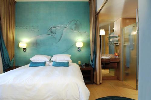 a bedroom with a white bed with a painting on the wall at Metcourt at Emperors Palace in Kempton Park