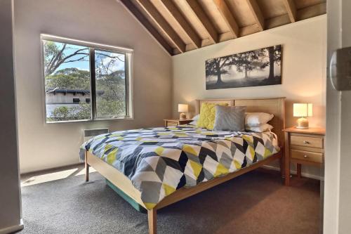 a bedroom with a bed and a window at Alpine Edge in Dinner Plain