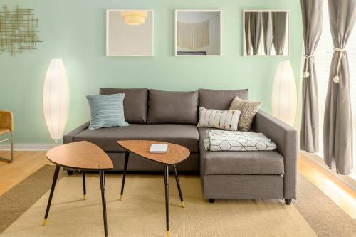 a living room with a couch and a table at Trifecta Spacious & Beautiful Wifi Superhost in Charlotte