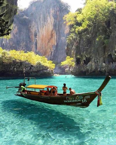 a group of people on a boat in the water at Phi Phi Maiyada Resort in Phi Phi Don