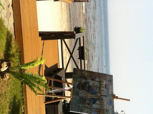 a painting on the side of a building next to a window at Villa Anna in Apšuciems