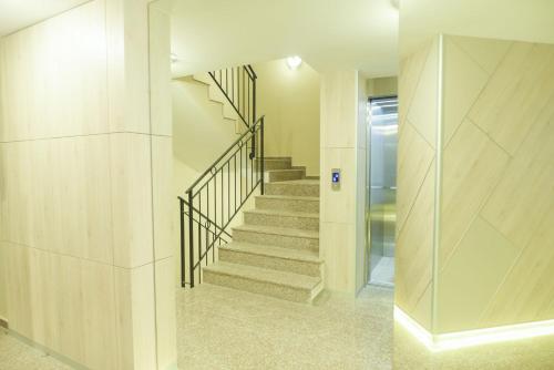 a staircase in a house with a glass wall at Noris Apart with Garage in Plovdiv