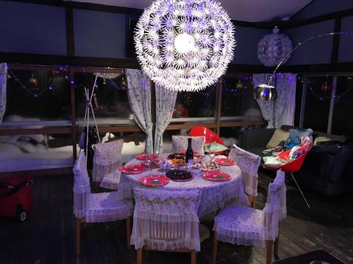 a purple table with chairs and a chandelier at Naeba Ski Resort - Cabin away from usual life in Yuzawa