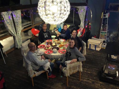 a group of people sitting around a table at Naeba Ski Resort - Cabin away from usual life in Yuzawa