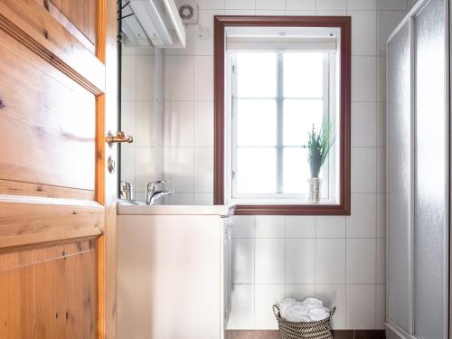 a bathroom with a sink and a window at XLyngen in Nord-Lenangen