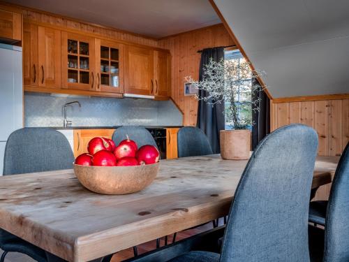 a bowl of apples on a wooden table in a kitchen at XLyngen in Nord-Lenangen
