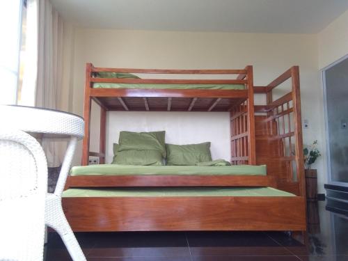 Cama con litera de madera y escalera en Seaview Mansion Dalaguete Apartment 4 -Family en Dalaguete