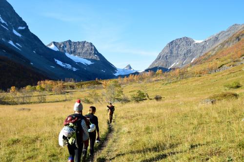 a group of people riding horses on a field at XLyngen in Nord-Lenangen